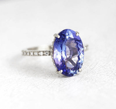 Purple Oval Tanzanite Platinum Ring with Round White Diamonds Nested in the Band