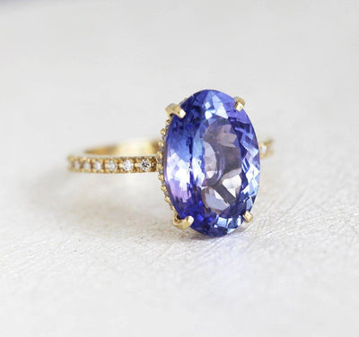 Purple Oval Tanzanite Yellow Gold Ring with Round White Diamonds Nested in the Band