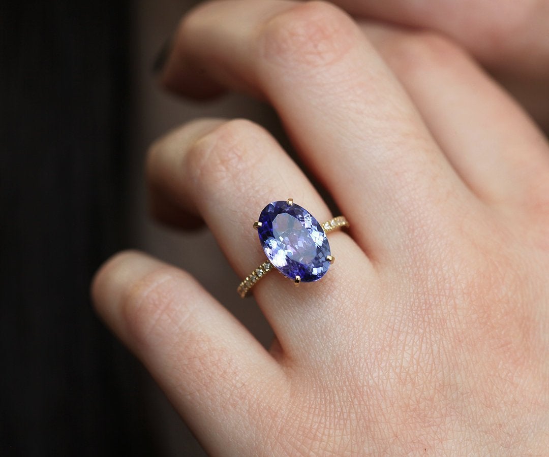 Purple Oval Tanzanite Yellow Gold Ring with Round White Diamonds Nested in the Band