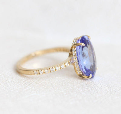 Purple Oval Tanzanite Yellow Gold Ring with Round White Diamonds Nested in the Band