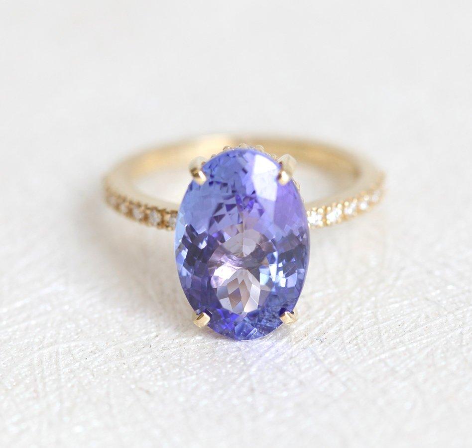 Purple Oval Tanzanite Yellow Gold Ring with Round White Diamonds Nested in the Band