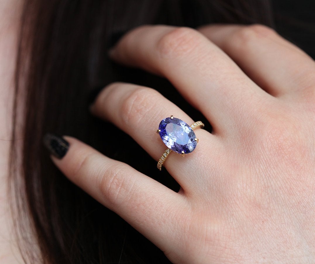 Purple Oval Tanzanite Yellow Gold Ring with Round White Diamonds Nested in the Band