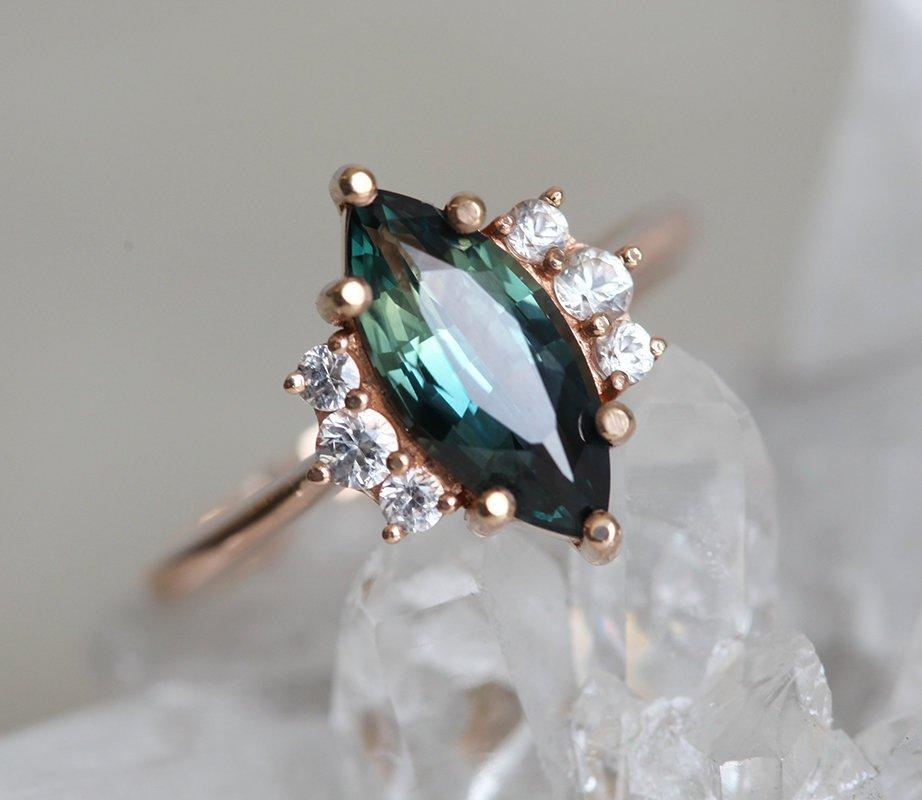 Vintage marquise-shaped teal sapphire ring with side diamonds