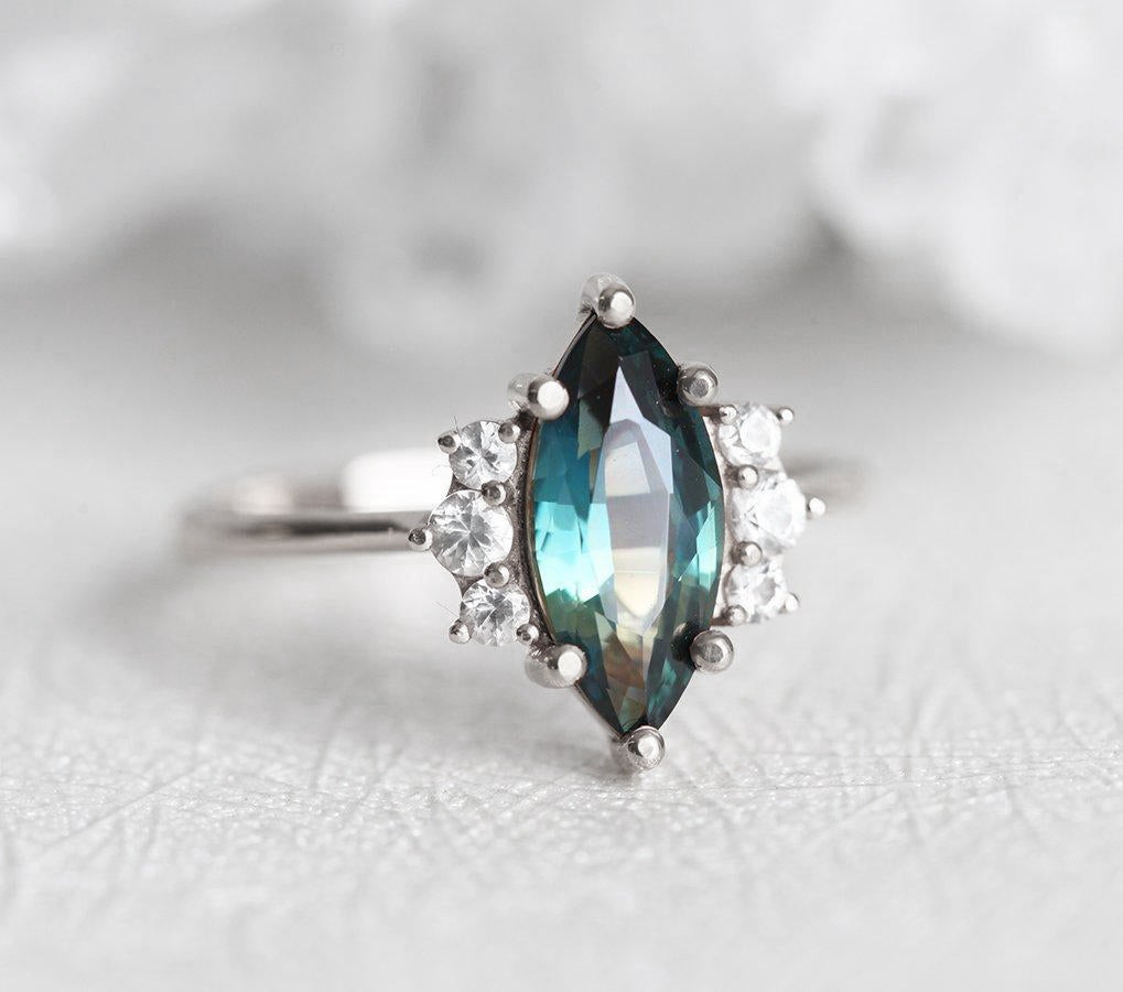 Vintage marquise-shaped teal sapphire ring with side diamonds