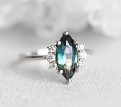 Vintage marquise-shaped teal sapphire ring with side diamonds