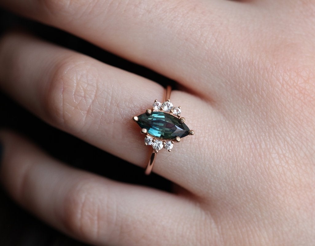 Vintage marquise-shaped teal sapphire ring with side diamonds