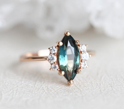 Vintage marquise-shaped teal sapphire ring with side diamonds