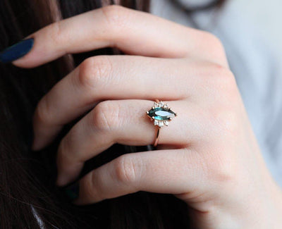 Vintage marquise-shaped teal sapphire ring with side diamonds