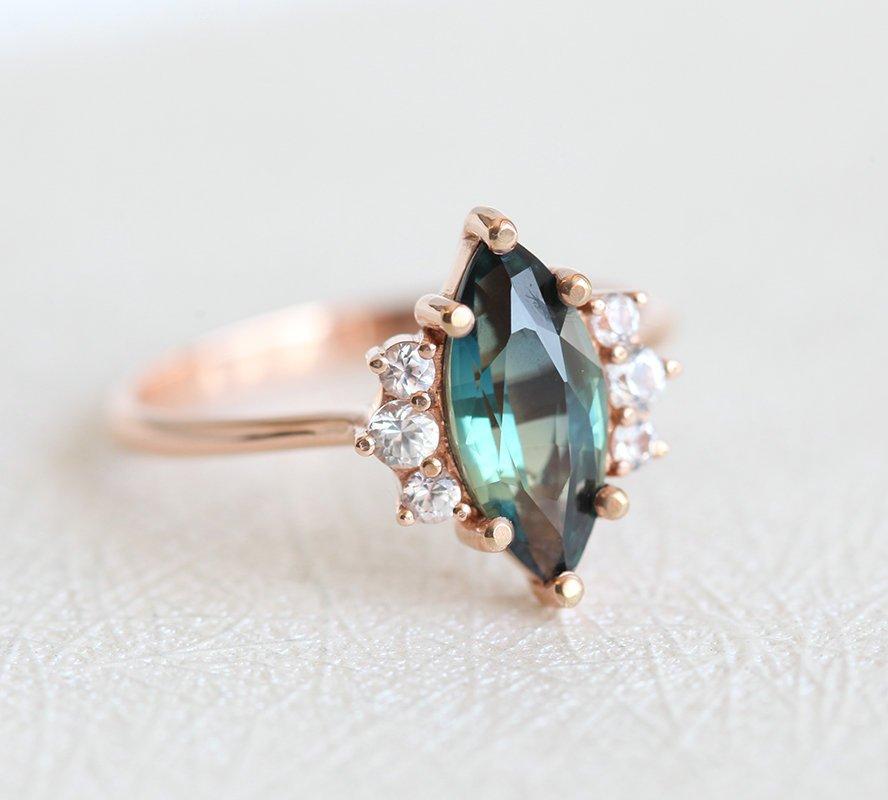 Vintage marquise-shaped teal sapphire ring with side diamonds