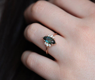 Vintage marquise-shaped teal sapphire ring with side diamonds