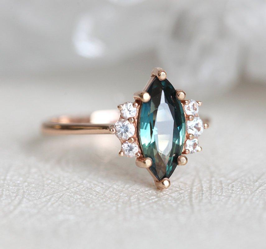 Vintage marquise-shaped teal sapphire ring with side diamonds