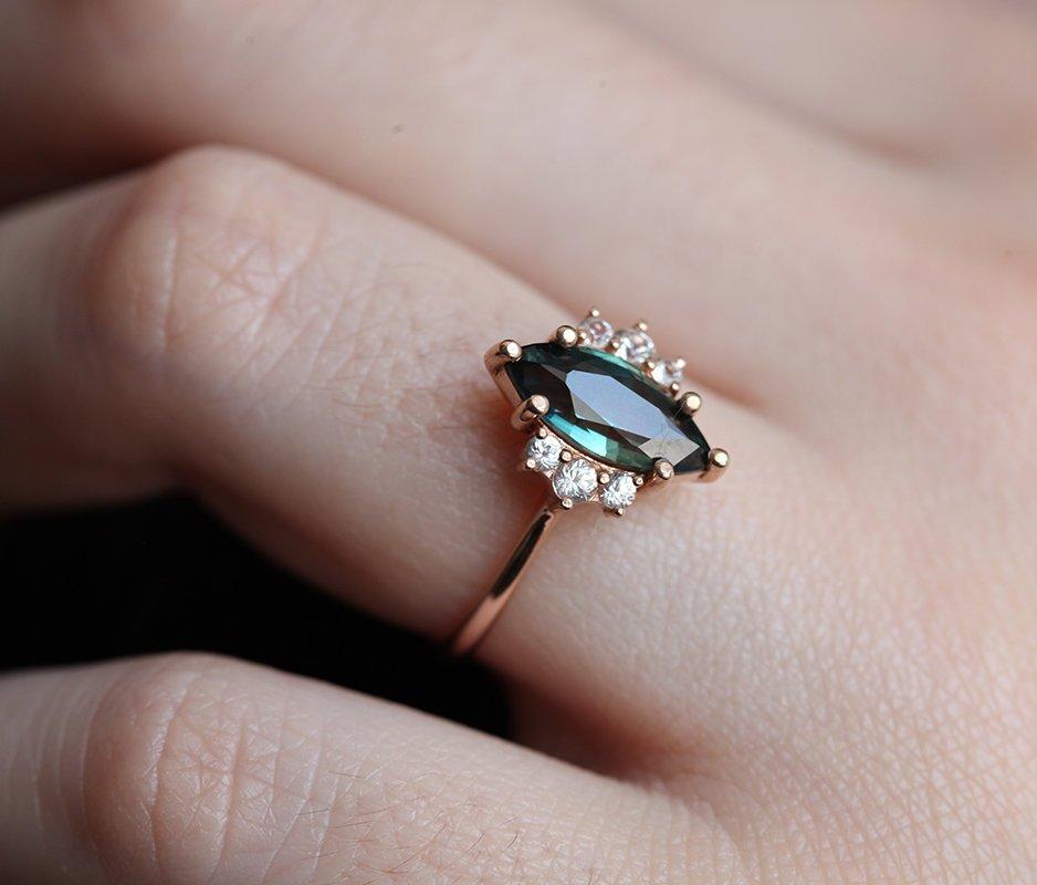 Vintage marquise-shaped teal sapphire ring with side diamonds