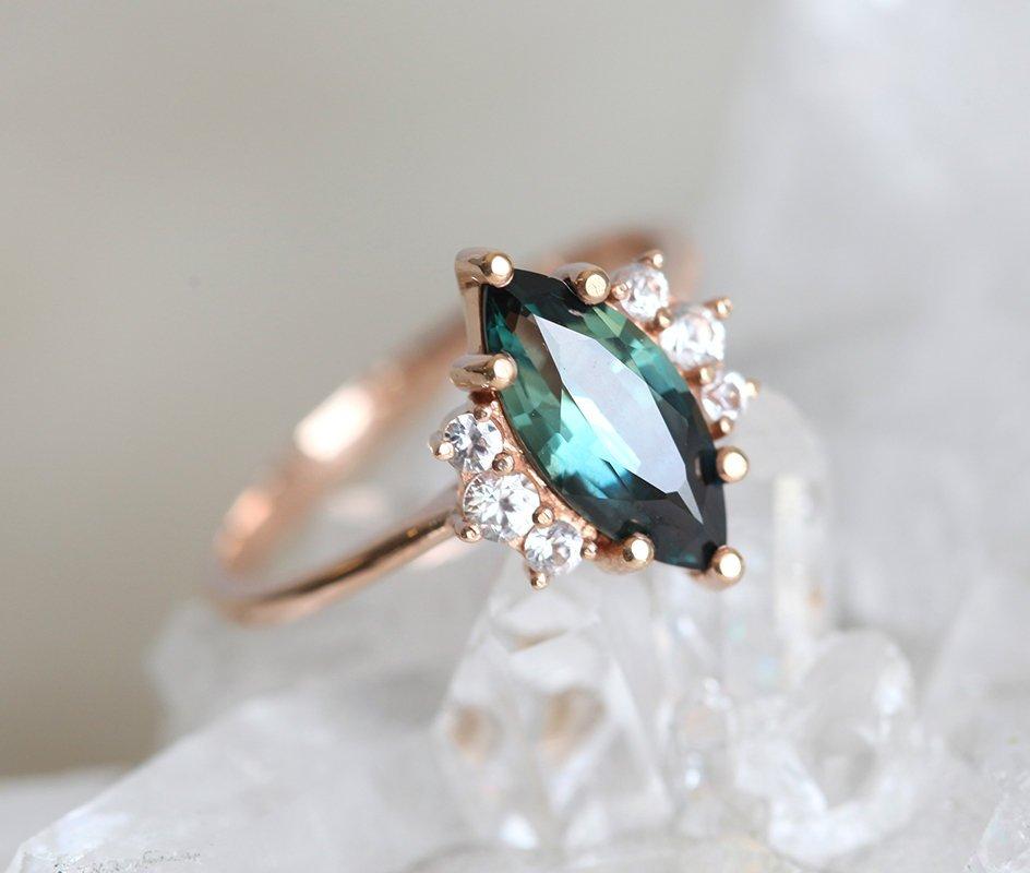 Vintage marquise-shaped teal sapphire ring with side diamonds
