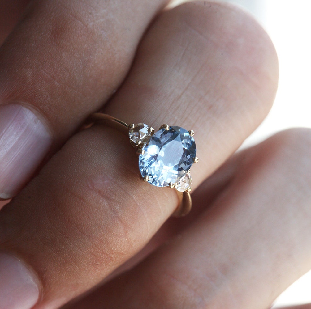 Blue oval sapphire ring with side diamonds