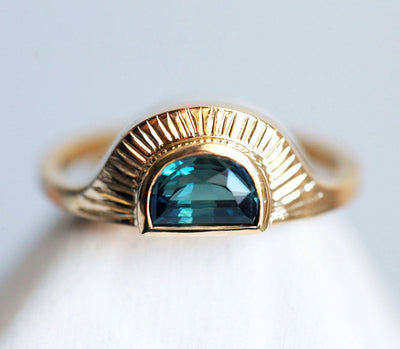 Half-moon-shaped teal sapphire ring