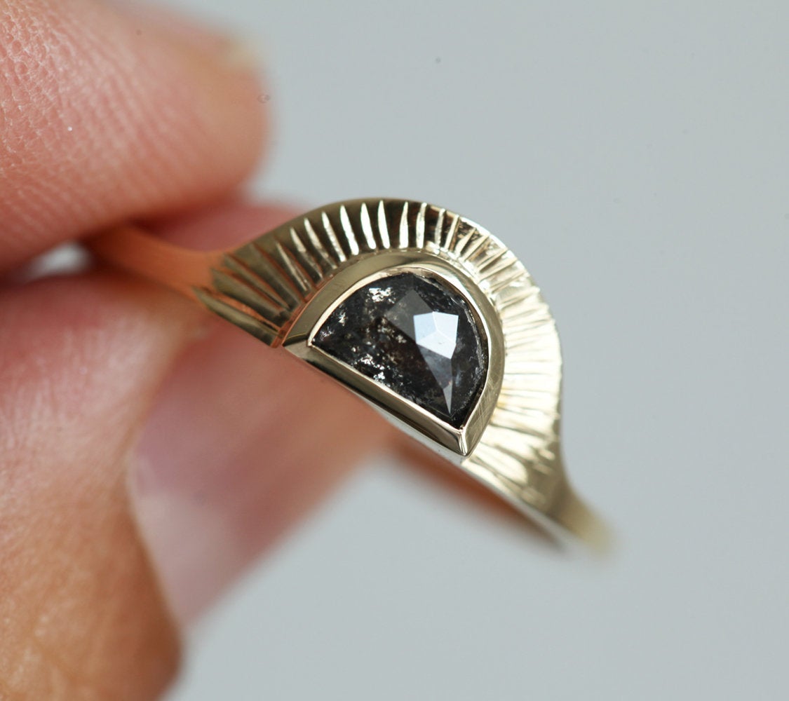 Half-moon-shaped teal sapphire ring