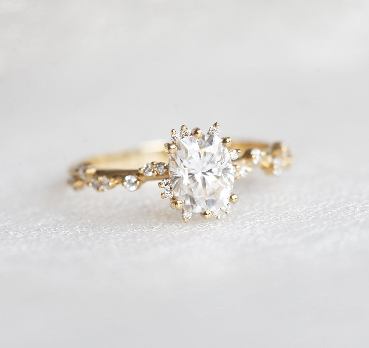 Oval White Diamond Cluster Ring with Side White Round Diamonds Placed like a vine leading to the center stone