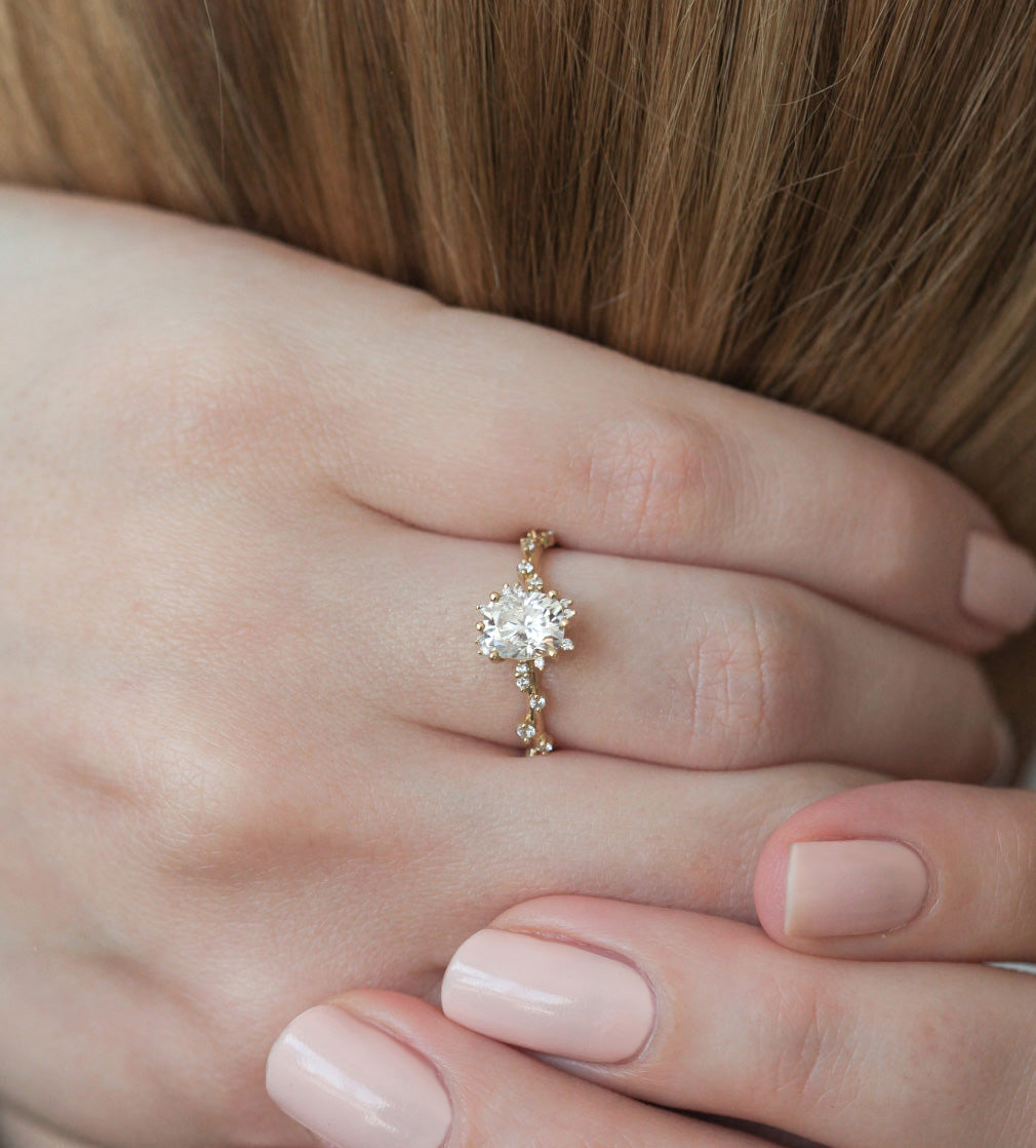 Oval White Diamond Cluster Ring with Side White Round Diamonds Placed like a vine leading to the center stone