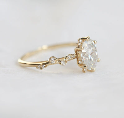 Oval White Diamond Cluster Ring with Side White Round Diamonds Placed like a vine leading to the center stone