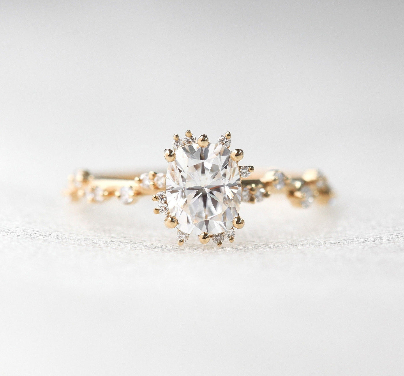 Oval White Diamond Cluster Ring with Side White Round Diamonds Placed like a vine leading to the center stone