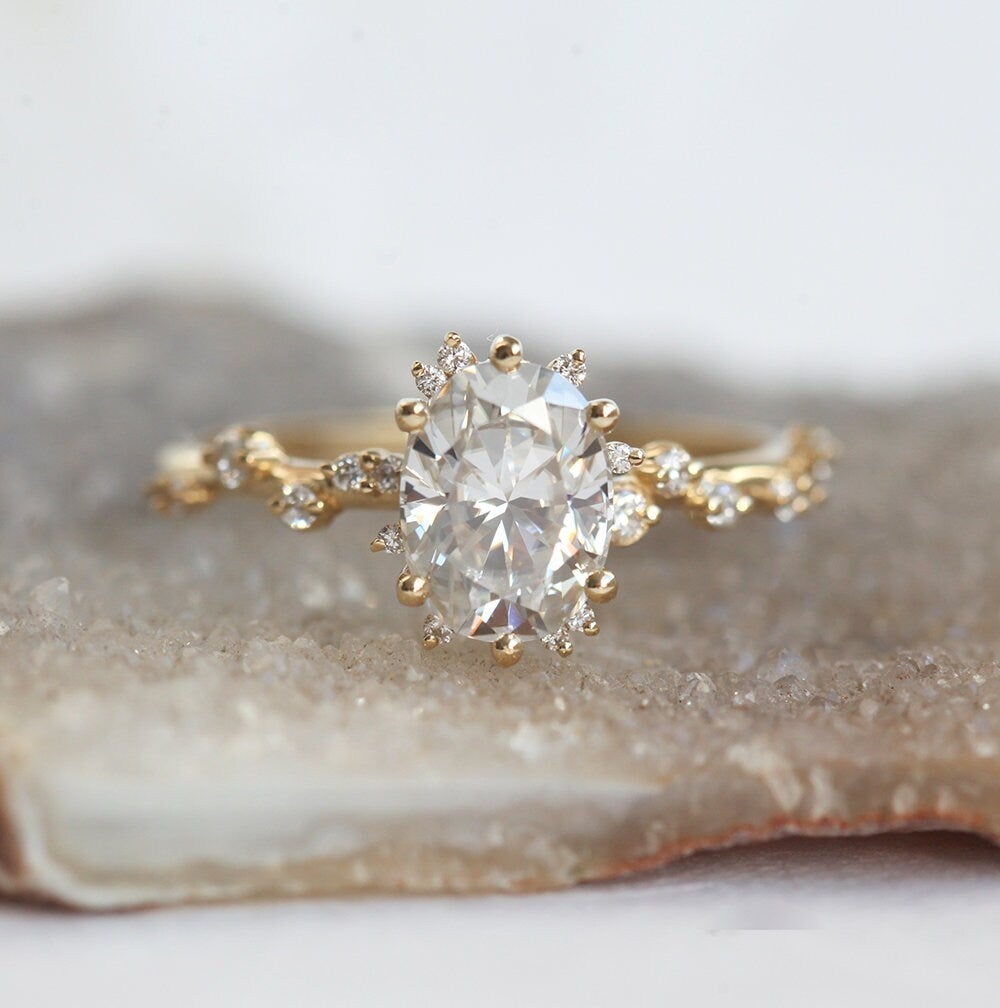 Oval White Diamond Cluster Ring with Side White Round Diamonds Placed like a vine leading to the center stone