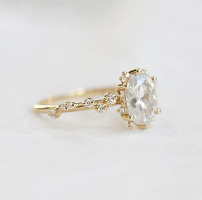 Oval White Diamond Cluster Ring with Side White Round Diamonds Placed like a vine leading to the center stone