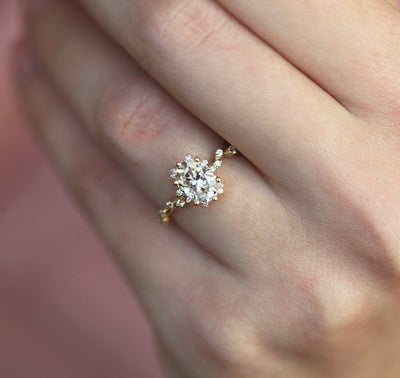 Oval White Diamond Cluster Ring with Side White Round Diamonds Placed like a vine leading to the center stone