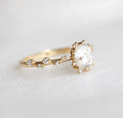 Oval White Diamond Cluster Ring with Side White Round Diamonds Placed like a vine leading to the center stone