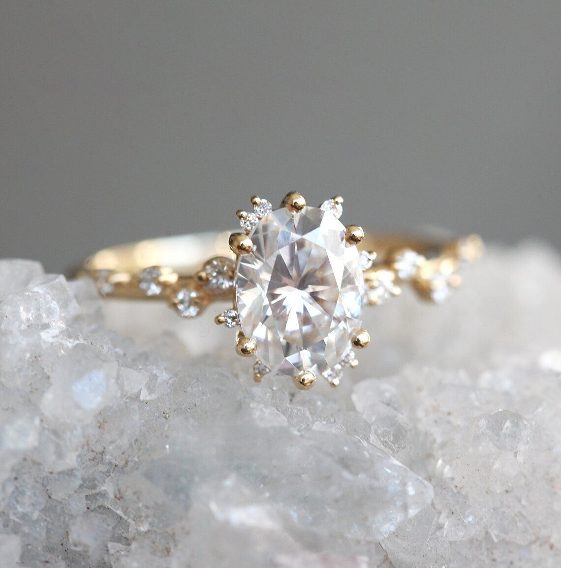 Oval White Diamond Cluster Ring with Side White Round Diamonds Placed like a vine leading to the center stone