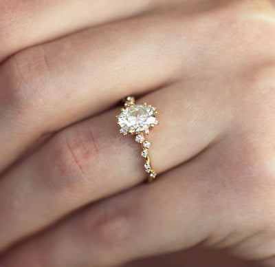 Oval White Diamond Cluster Ring with Side White Round Diamonds Placed like a vine leading to the center stone