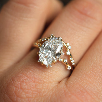 Bokeh Oval Diamond Ring featuring a hand with a 3ct lab-grown diamond ring.