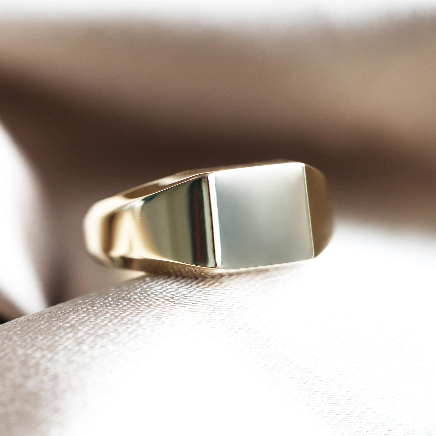 Gold signet ring with plain style, 9.3mm front width, and polished finish. Customizable with gemstones. Made from premium metals like sterling silver, gold, and platinum.
