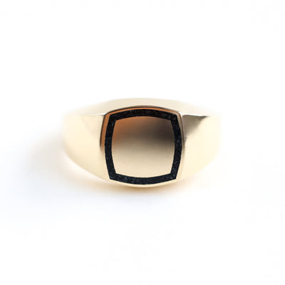 Close-up of a Brad gold inlay signet ring showcasing its intricate details.