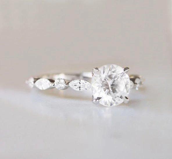 Round white sapphire ring with side diamonds