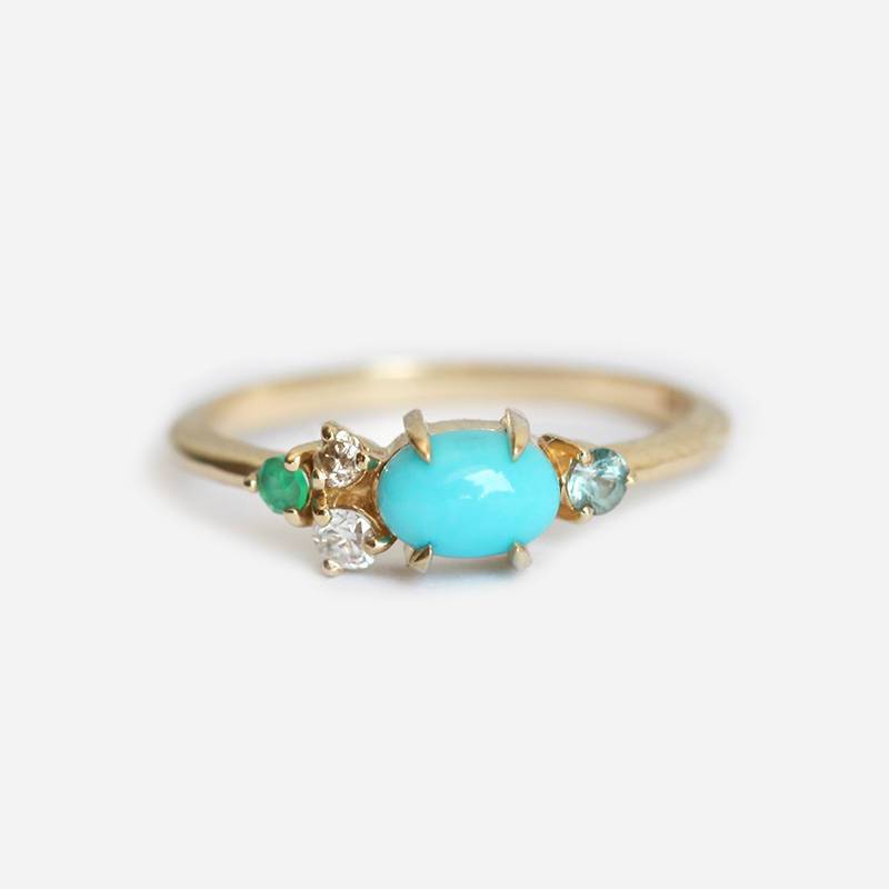 Oval-shaped blue turquoise, sapphire, emerald and diamond cluster ring