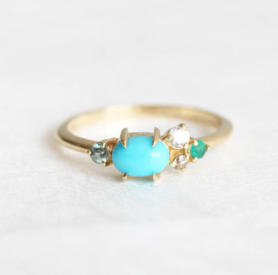 Oval-shaped blue turquoise, sapphire, emerald and diamond cluster ring