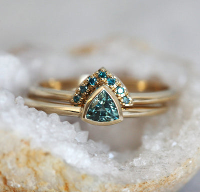 Trillion-shaped teal sapphire ring with nested diamonds
