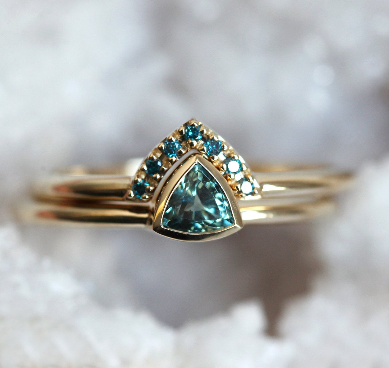 Trillion-shaped teal sapphire ring with nested diamonds