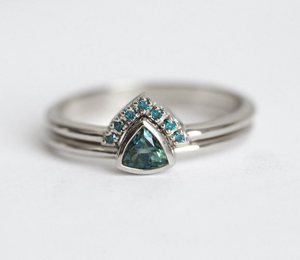 Trillion-shaped teal sapphire ring with nested diamonds