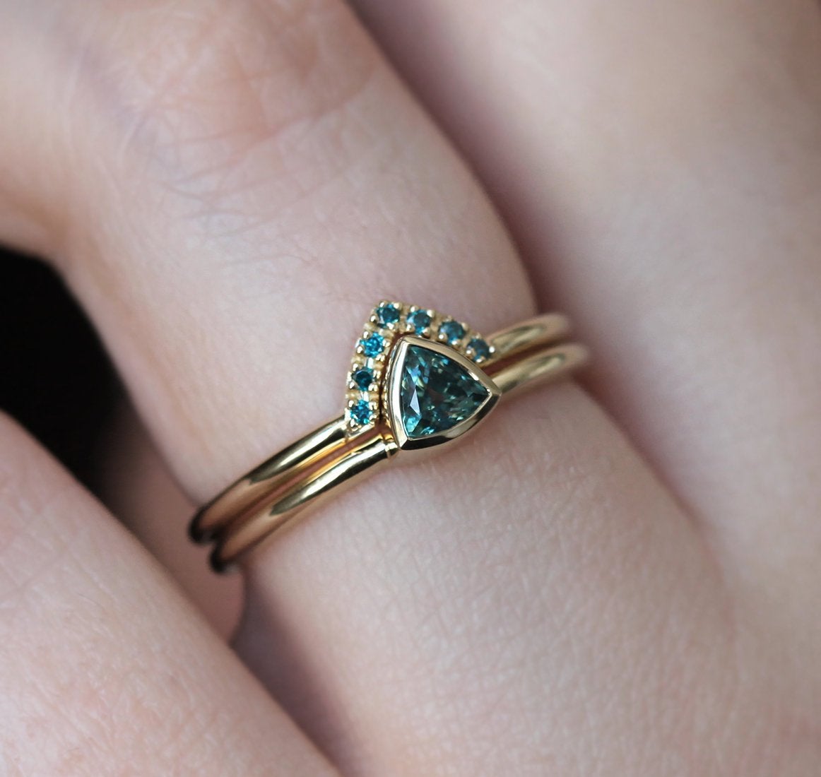 Trillion-shaped teal sapphire ring with nested diamonds