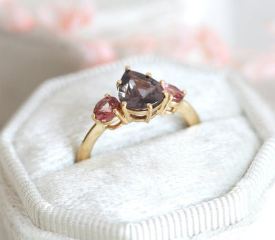 Pear-shaped burgundy sapphire ring with side garnets