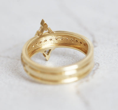 Gold ring with 2 triangular white diamonds with a middle eternity diamond ring