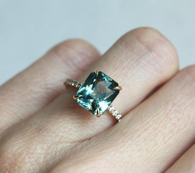 Radiant cut mint sapphire ring with side diamonds