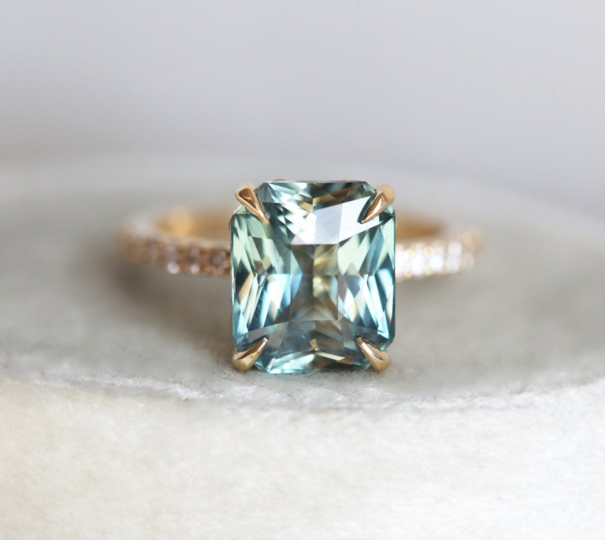 Radiant cut mint sapphire ring with side diamonds