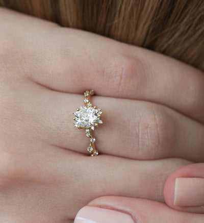 Oval White Diamond Cluster Ring with Side White Round Diamonds Placed like a vine leading to the center stone