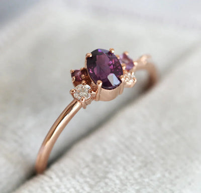 Purple oval sapphire ring with cluster diamonds and amethyst