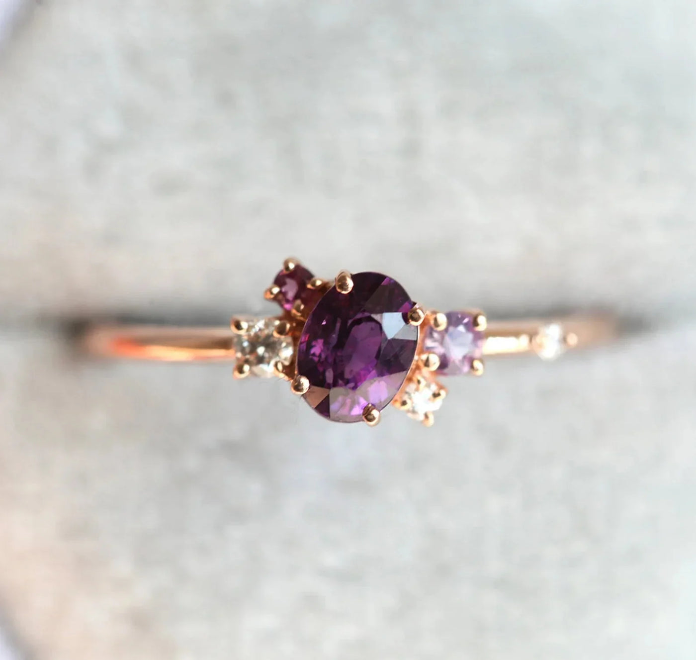 Purple oval sapphire ring with cluster diamonds and amethyst