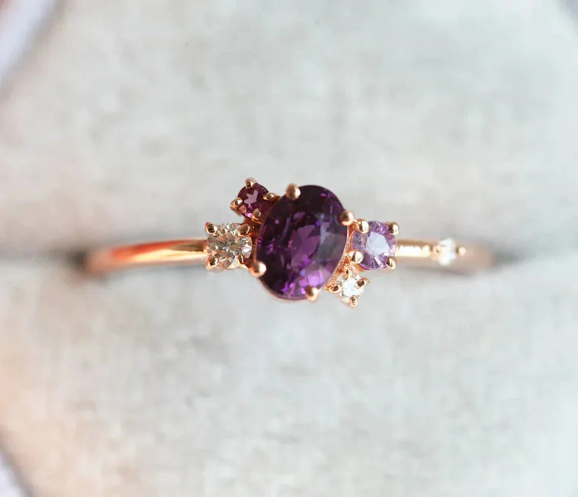 Purple oval sapphire ring with cluster diamonds and amethyst