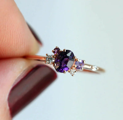 Purple oval sapphire ring with cluster diamonds and amethyst