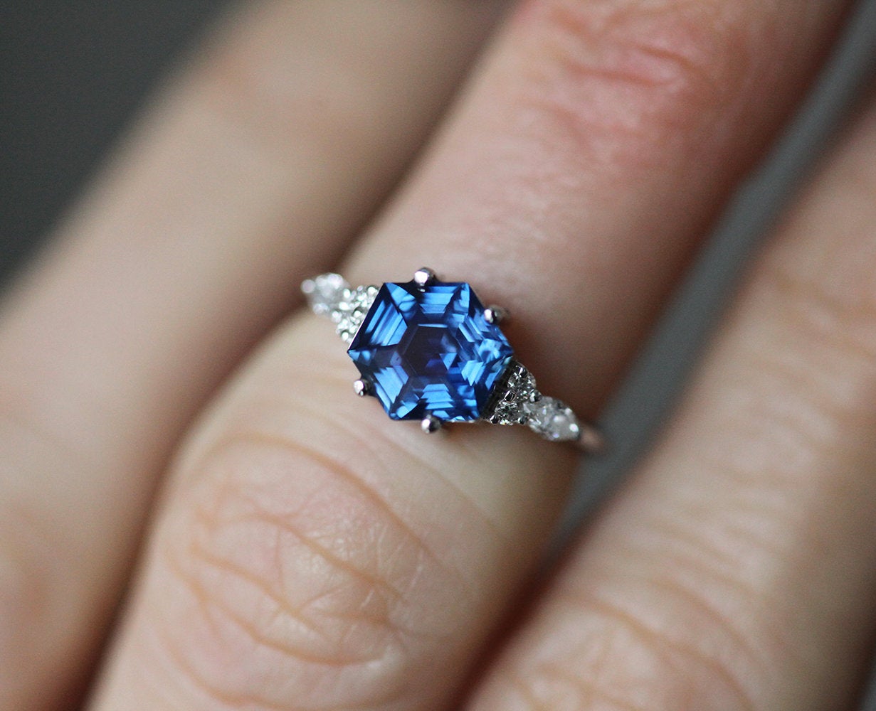 Blue hexagon-shaped sapphire ring with side diamonds